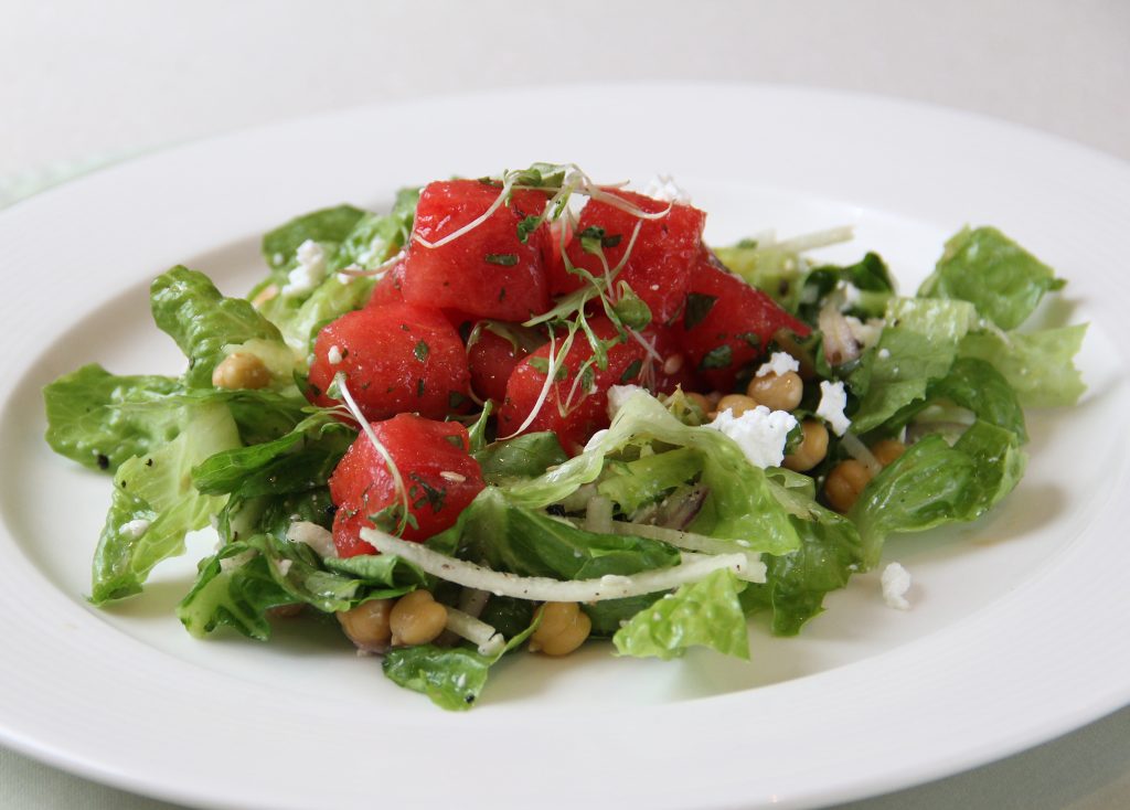 Plate of Watermelon Salad with Romaine lettuce, watermelon cubes, kesong puti, chickpeas, singkamas, onion, and microgreens